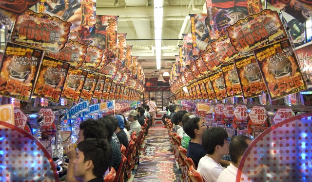 Pachinko parlour with rows of machines with colourful lights and gaudy music, Japan