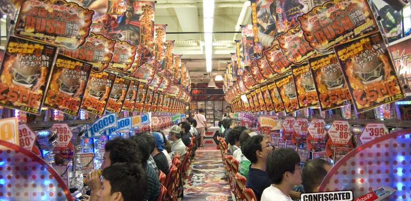 Pachinko parlour with rows of machines with colourful lights and gaudy music, Japan