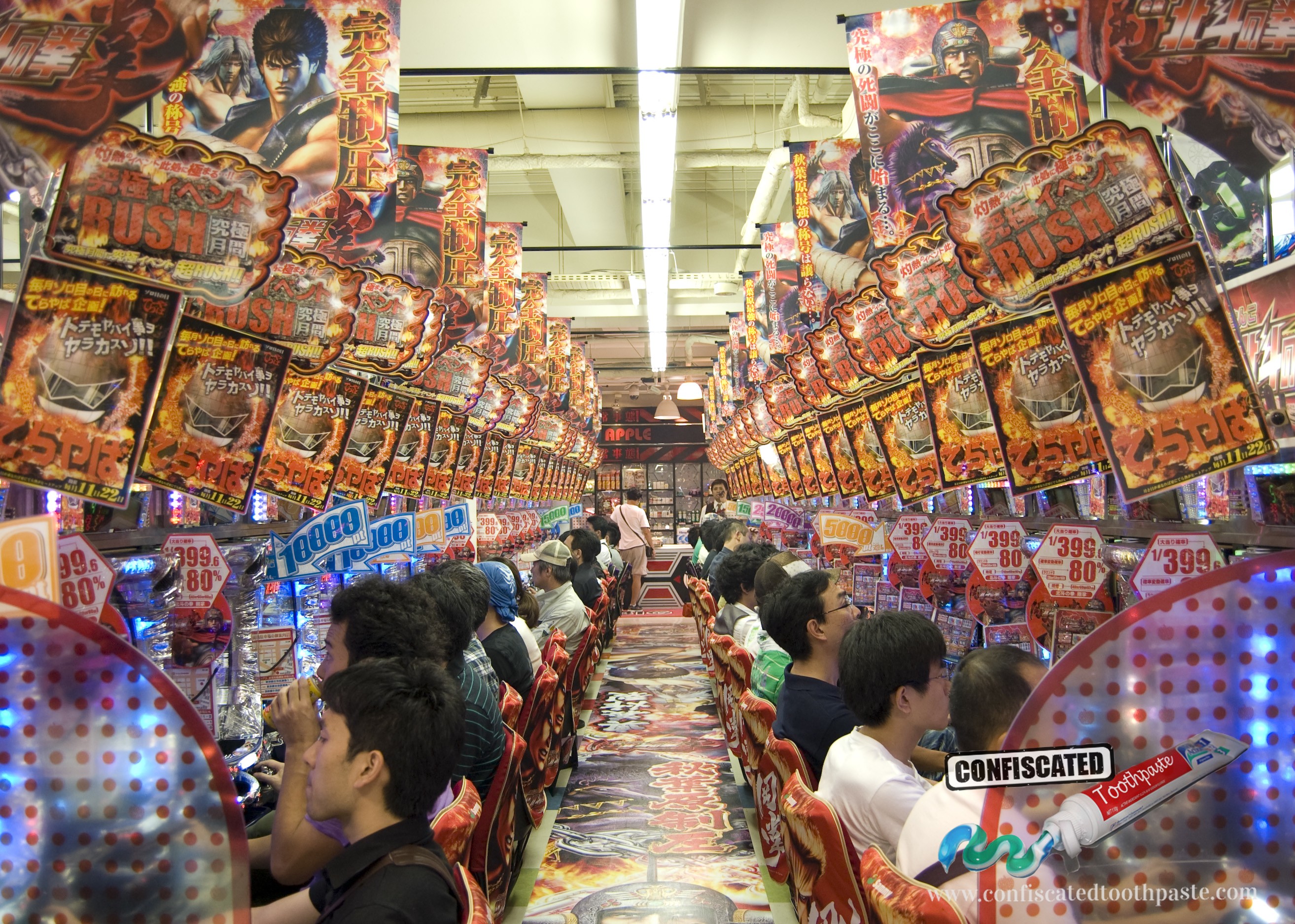 Pachinko parlour with rows of machines with colourful lights and gaudy music, Japan