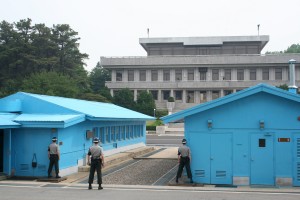 Looking towards North Korea from the UN Joint Security Area, Panmunjom. South Korean soldiers guard the border, which is the concrete threshold between the huts.