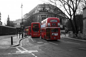The ubiquitous red double deckers trundle through England's capital along Fleet Street towards Trafalgar Square.