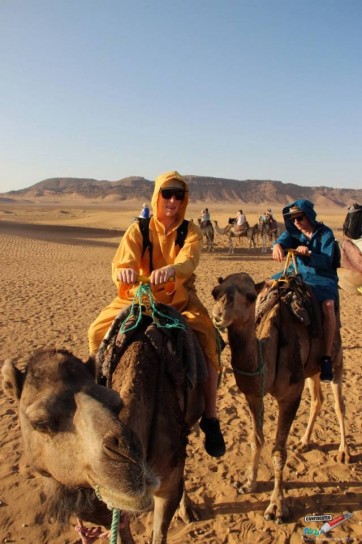 My friend Luke and I in our stylish blue and yellow jellabas respectively, whilst riding camels in the Saharan desert.