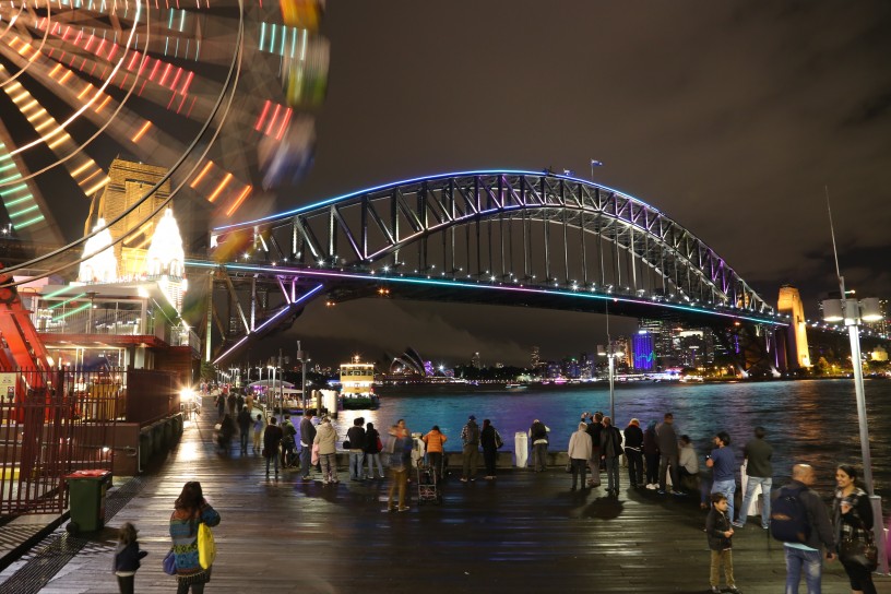 Sydney Harbour Bridge in Aqua and Pink with Ferry and Luna Park Ferris Wheel, Vivid Festival 2014